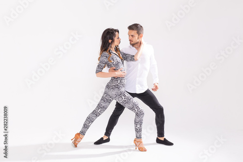 Salsa, kizomba, tango and bachata dancers on white background with copy space. Social dance concept