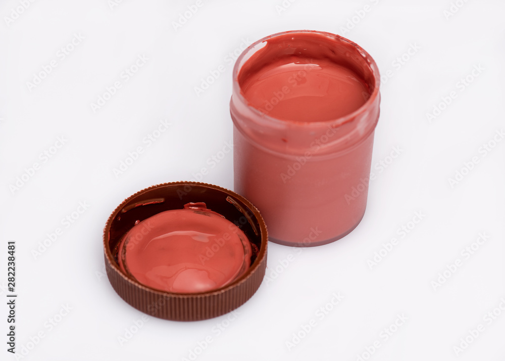 Opened brown Gouache jar, on white background with copy space. Cans of different colors gouache paints. Opened brown Gouache jar, on white background with copy space. Cans of different colors gouache paints.