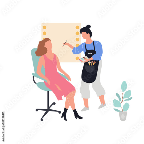 Make up artist standing and holding palette and cosmetic