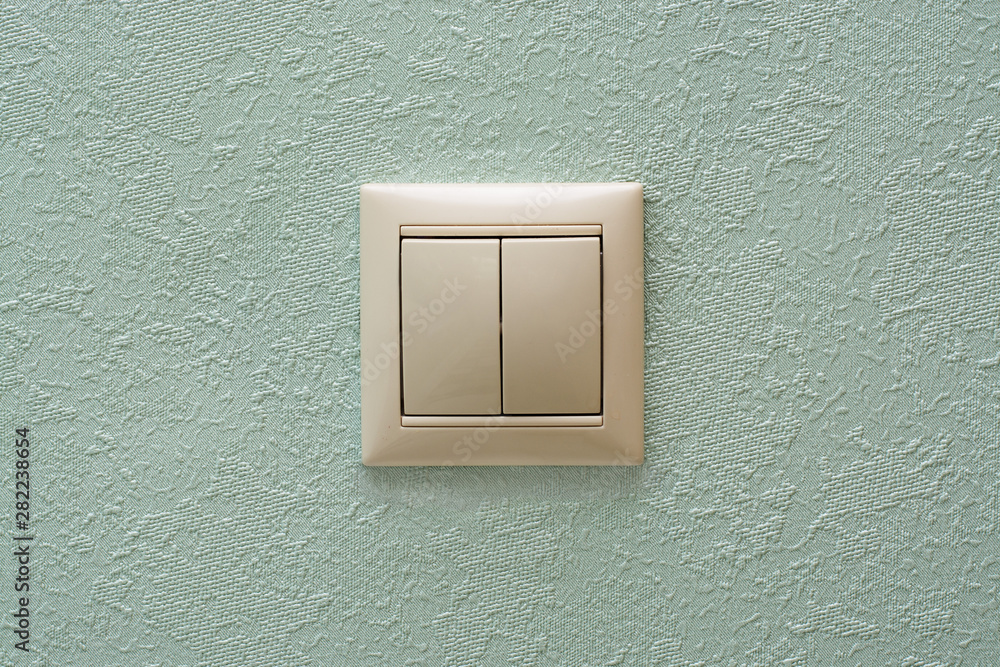 light switch, a white plastic mechanical switch mounted on a light blue wall. Copy space light switch, a white plastic mechanical switch mounted on a light blue wall. Copy space