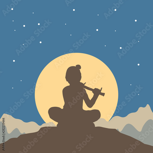 Lord Krishna in Happy Janmashtami festival. Background for greeting card of Krishna's Birthday with silhouette sitting on top of a hill against of a night starry sky, moon and mountain landscape.