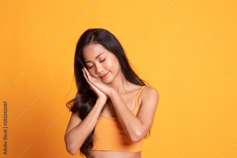 Beautiful young Asian woman with sleeping gesture. Beautiful young Asian woman with sleeping gesture.