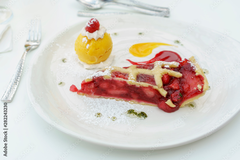 Homemade warm apple and damson plum tart and mango sorbet served in restaurant in Scotland Homemade warm apple and damson plum tart and mango sorbet served in restaurant in Scotland