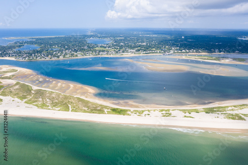 The nutrient-rich waters of the Atlantic Ocean bathe a scenic beach on Cape Cod, Massachusetts. This beautiful area of New England, not too far from Boston, is a popular summer vacation destination. photo