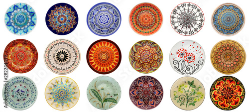 Set of decorative ceramic dishes hand-painted with acrylic paints floral pattern isolated on white background