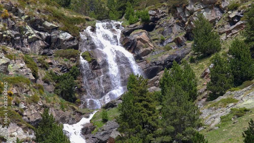 Big waterfall in Spanish Pyrenees mountains, near Valley of Nuria Big waterfall in Spanish Pyrenees mountains, near Valley of Nuria