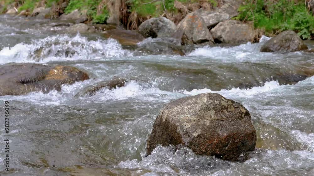 Abounding river detail with close up of rock, in Spanish Pyrenees mountains Abounding river detail with close up of rock, in Spanish Pyrenees mountains