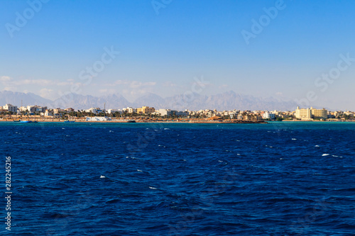 Beautiful view of the coastline with houses and hotels in Hurghada, Egypt. View from Red sea © olyasolodenko