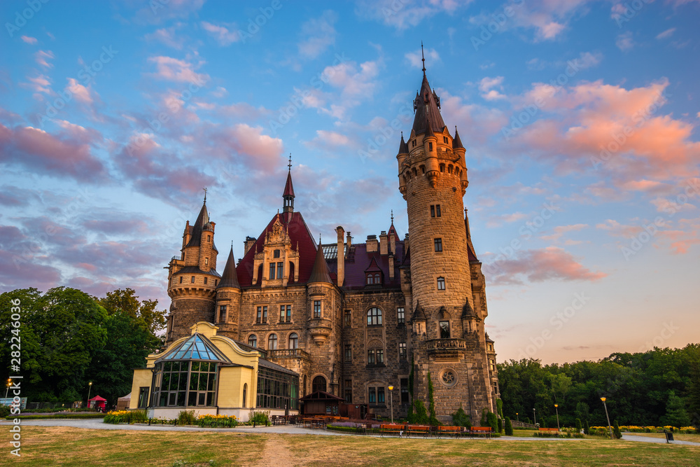 Moszna near Opole,Lower Silesia, Poland-July 2019:Castle in Moszna in the rays of the rising sun, near Opole, Silesia, Poland. Moszna near Opole,Lower Silesia, Poland-July 2019:Castle in Moszna in the rays of the rising sun, near Opole, Silesia, Poland.