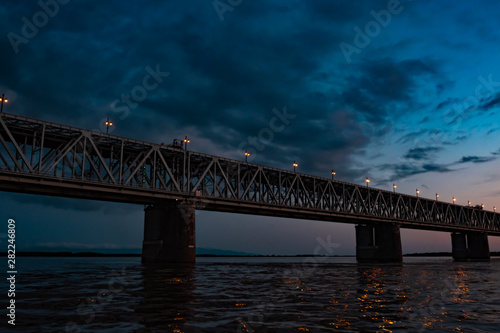 Bridge over the Amur river at sunset. Russia. Khabarovsk. Photo from the middle of the river.