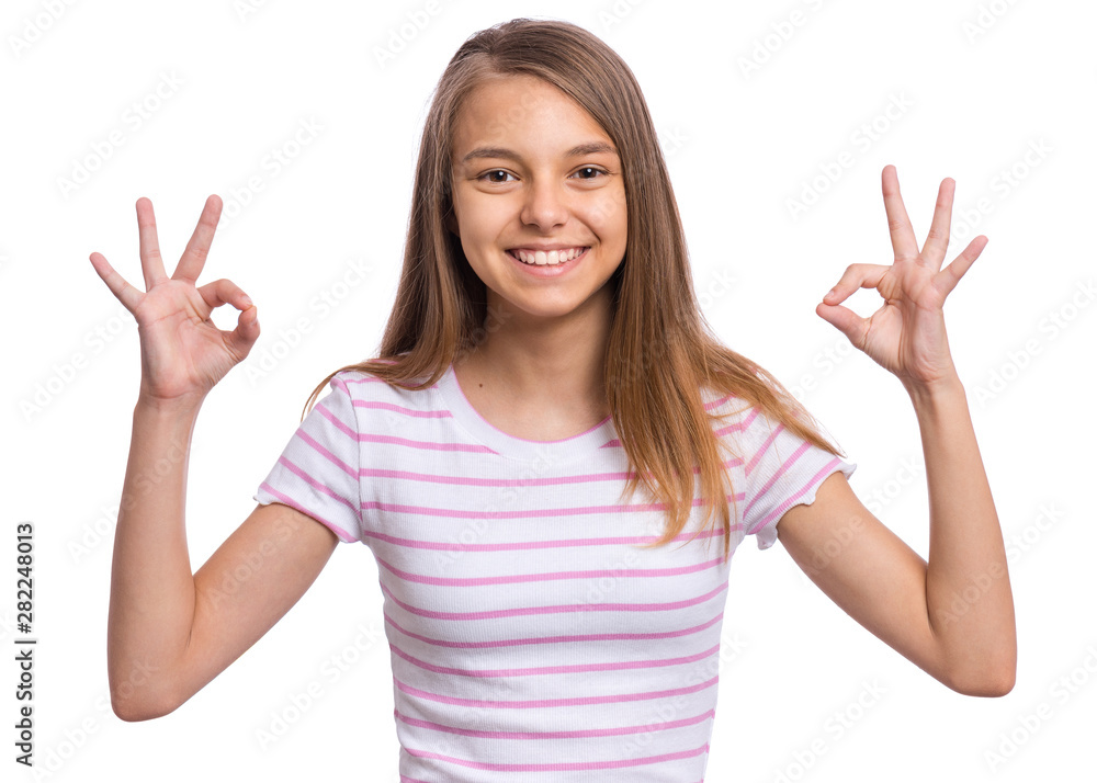 Portrait of teen girl making Ok Gesture, isolated on white background. Beautiful caucasian young teenager smiling and giving OK sign. Happy cute child showing okay. Portrait of teen girl making Ok Gesture, isolated on white background. Beautiful caucasian young teenager smiling and giving OK sign. Happy cute child showing okay.