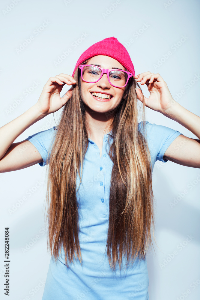 young pretty teenage modern hipster girl posing emotional happy isolated on white background, wearing pink hat and glasses, lifestyle people concept young pretty teenage modern hipster girl posing emotional happy isolated on white background, wearing pink hat and glasses, lifestyle people concept