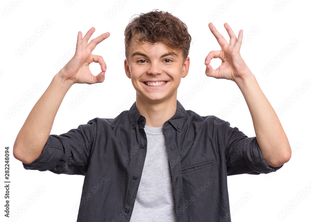 Portrait of teen boy making Ok Gesture, isolated on white background. Handsome caucasian young teenager smiling and giving OK sign. Happy cute child showing okay. Portrait of teen boy making Ok Gesture, isolated on white background. Handsome caucasian young teenager smiling and giving OK sign. Happy cute child showing okay.