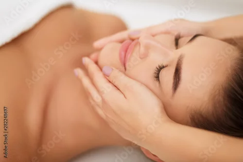 Obraz Woman getting face massage at beauty salon, closeup