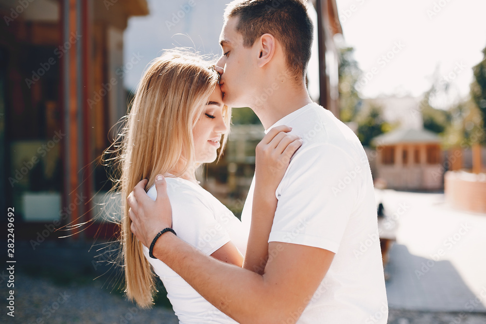 Cute couple in a park. Lady in a white t-shirt. Cute couple in a park. Lady in a white t-shirt.
