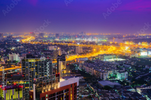 Aerial view of central business district, commercial and residential area at night of Bangkok, Thailand