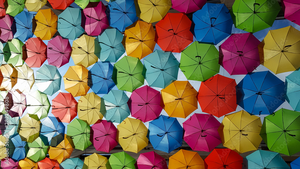 Street decorated with bright colorful umbrellas for background wallpaper on the sky in sun day