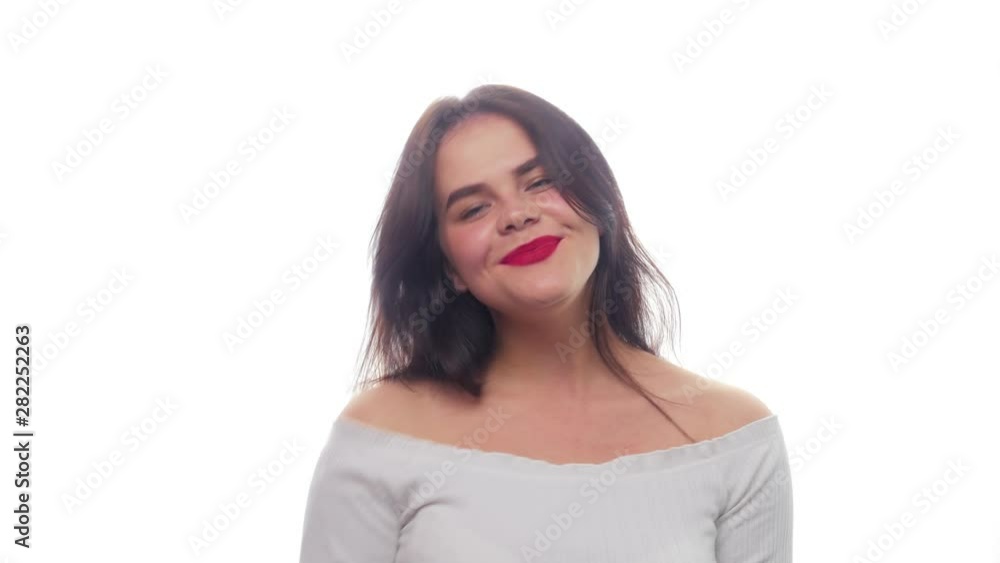 Beautiful sweet girl playfully jumps into the frame - White background - Face expressions Beautiful sweet girl playfully jumps into the frame - White background - Face expressions