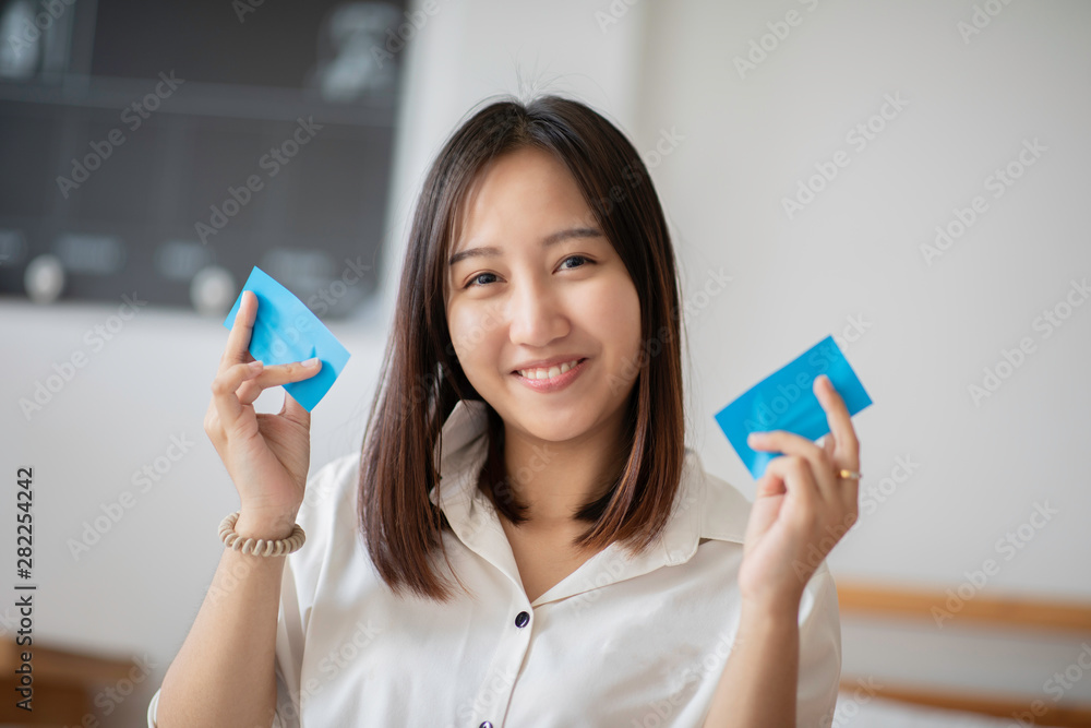 Beautiful Attractive Asian woman using Facial oil clean film to removal oil on face for face fresh skin feeling so fresh and clean,Beauty Concept Beautiful Attractive Asian woman using Facial oil clean film to removal oil on face for face fresh skin feeling so fresh and clean,Beauty Concept