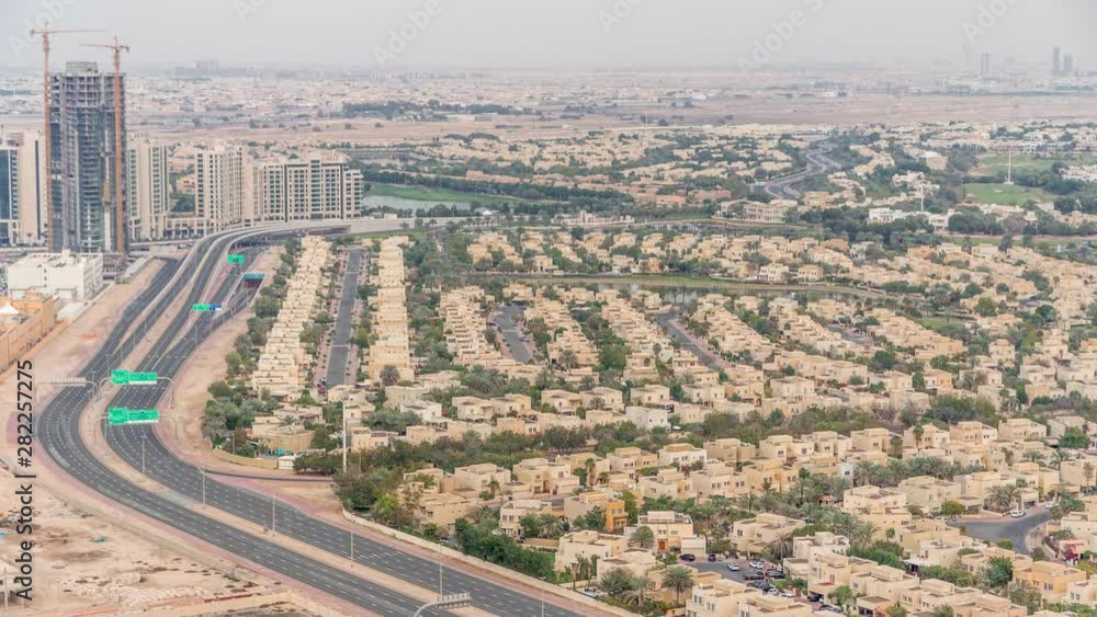 Aerial view of apartment houses and villas in Dubai city timelapse near jumeirah lake towers district, United Arab Emirates. Top fiew from skyscraper Aerial view of apartment houses and villas in Dubai city timelapse near jumeirah lake towers district, United Arab Emirates. Top fiew from skyscraper
