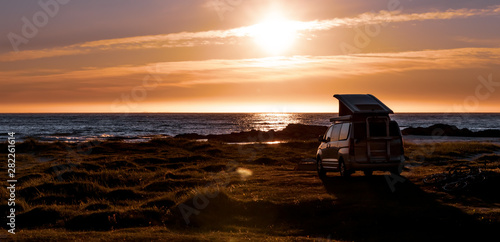 Camping car minivan on the beach at sunset Lofoten beach.