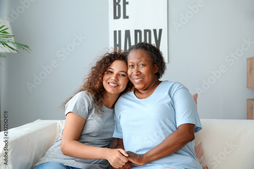 Portrait of African-American woman with her daughter at home © Pixel-Shot