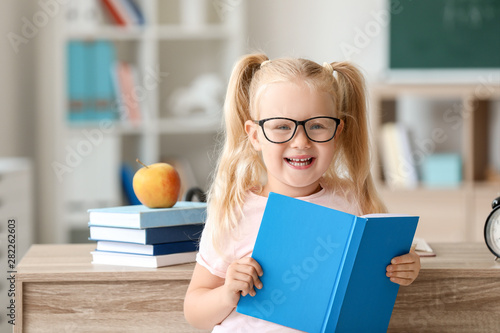 Smart little schoolgirl wit...