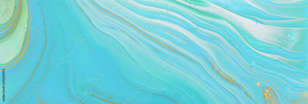 photography of abstract marbleized effect background. Blue, gold and turquoise creative colors. Beautiful paint. banner