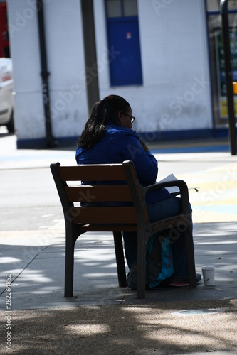 person seating on a city park chair