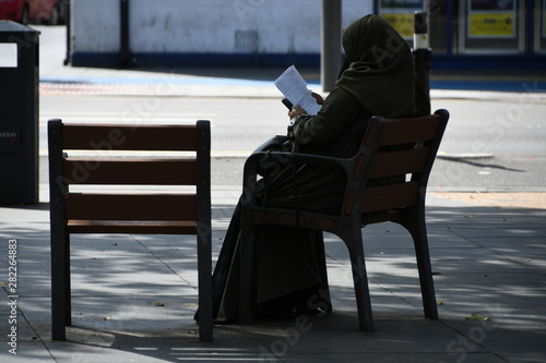 person seating on a city park chair