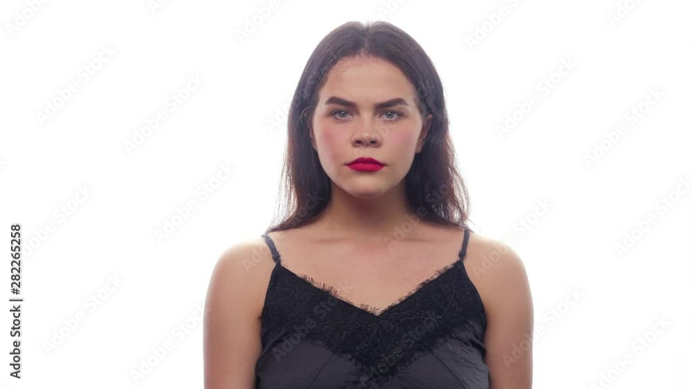 The girl is offended, frowns and crosses hands - white background - face expressions The girl is offended, frowns and crosses hands - white background - face expressions