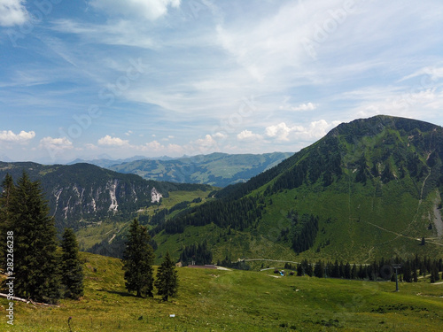 Beautiful alpine landscape with green meadows, alpine cottages and mountain peaks, Tyrol Alps, Austria