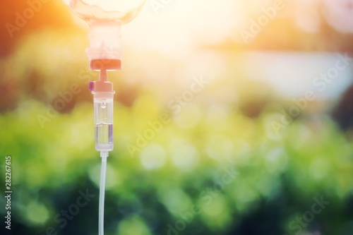 Tableau sur toile Chemotherapy drug medical holding hypodermic syringe needle injection iv bag fluid intravenous drop saline drip hospital room concept treatment  palliative care