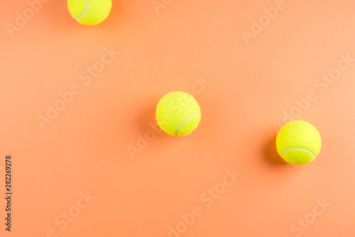 Three tennis balls on orange. Concept © tenkende