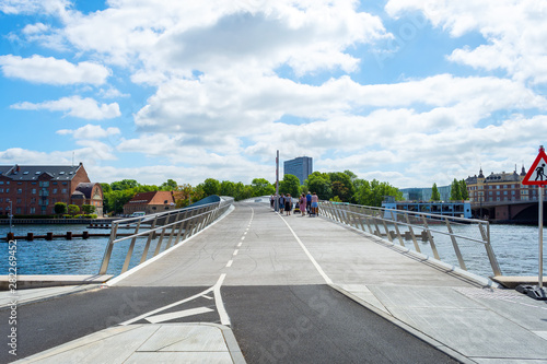 Beautiful pedestrian  bicycle bridge over the canal. Denmark. Copenhagen. Architecture. Sights.