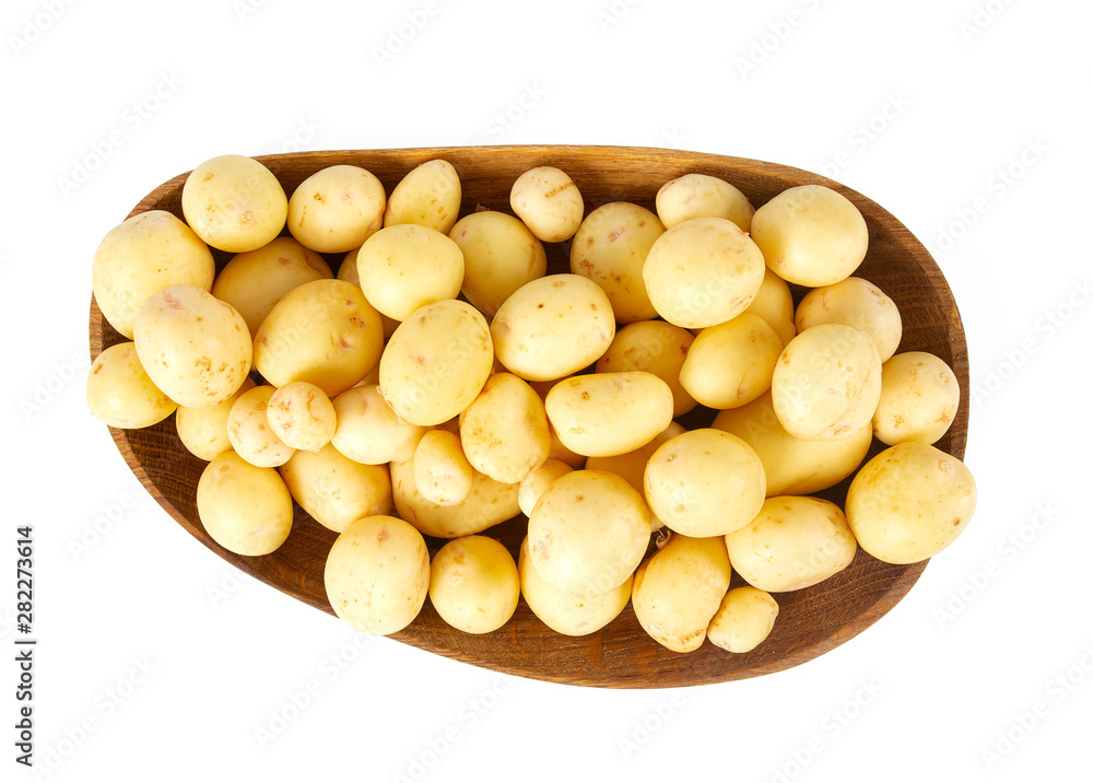 young potatoes on wooden plate isolated on white young potatoes on wooden plate isolated on white
