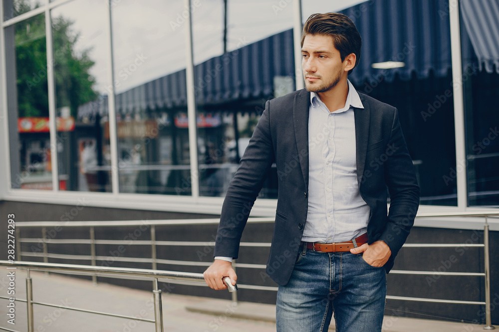 Man in a stylish suit. Businessman in a summer city Man in a stylish suit. Businessman in a summer city