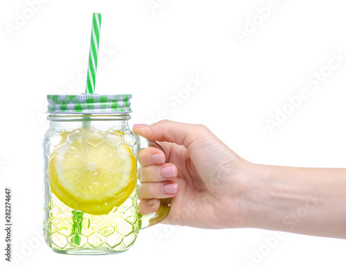 Mason jar glass with lemon water in hand on white background isolation