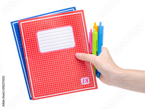 School exercise book notebook with pen in hand education on white background isolation