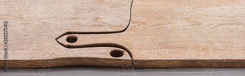 panoramic shot of wooden and brown chopping boards with copy space