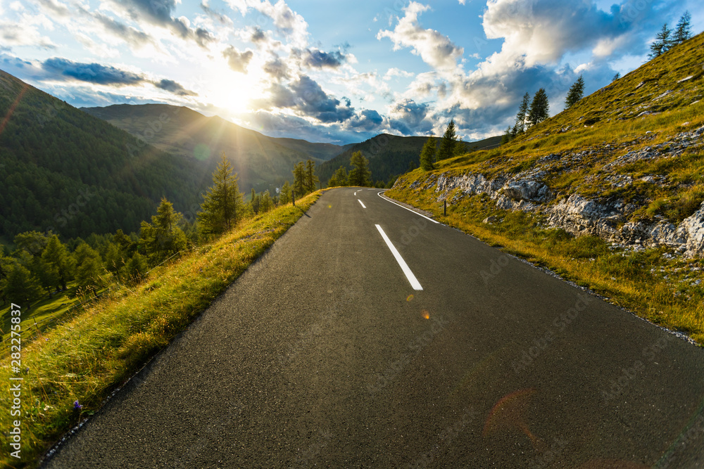 Asphalt road in Austria, Alps in a summer day. - obrazy, fototapety, plakaty 