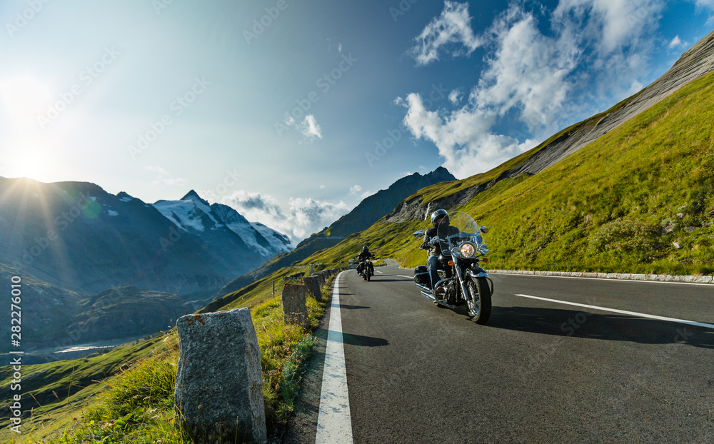 Fototapeta premium Motorcycle driver riding in Alpine highway, Nockalmstrasse, Austria, Europe.