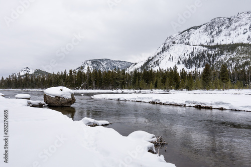 Canvas Print Winter scene  of a river and snow covered mountains in Yellowstone National Park, Wyoming