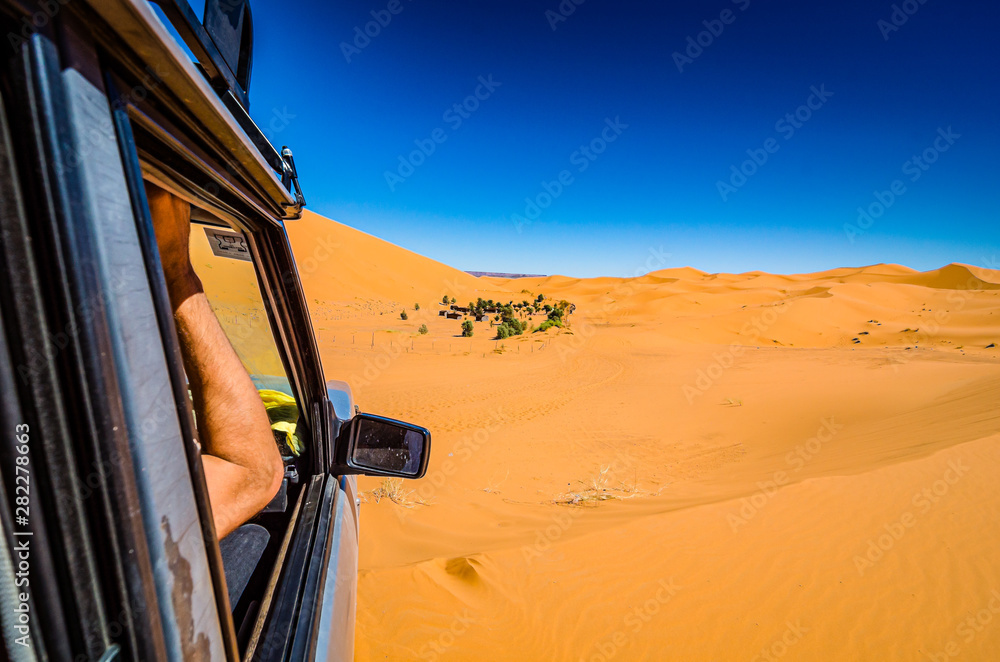 Off road car learning how to drive in sand dunes in Erg Chebbi, Morocco