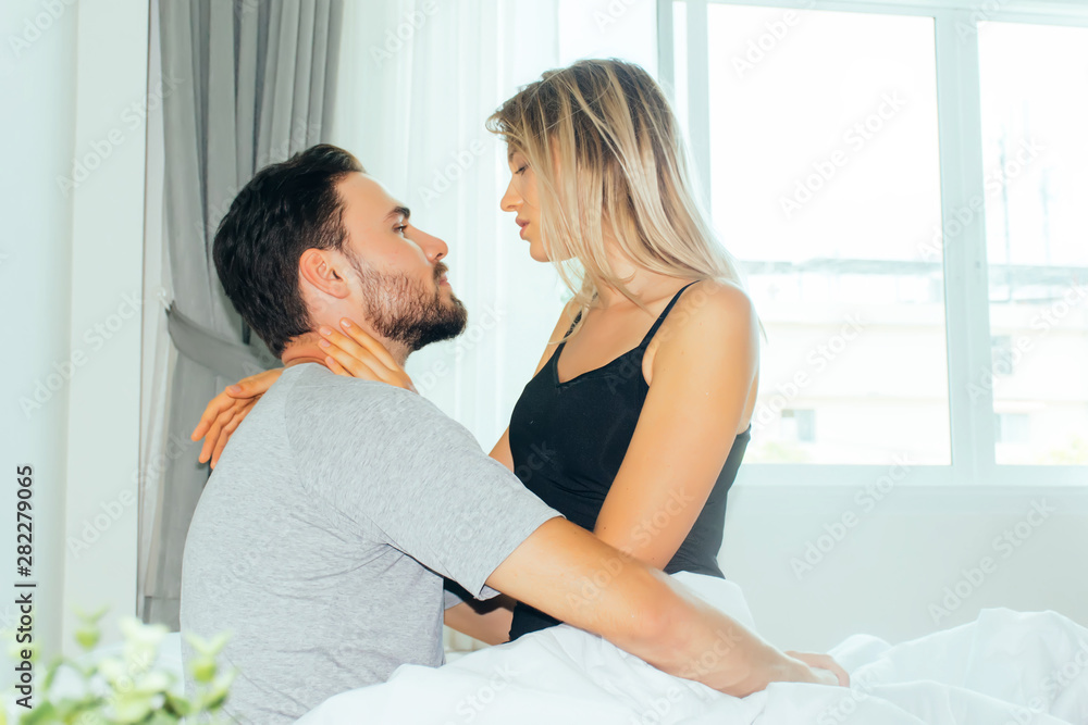 happy couple lying together in bed.loving couple kissing in bed. happy couple lying together in bed.loving couple kissing in bed.