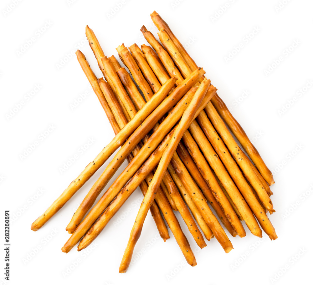 Pile of cookie sticks with poppy seeds on a white. The view of the top. Pile of cookie sticks with poppy seeds on a white. The view of the top.