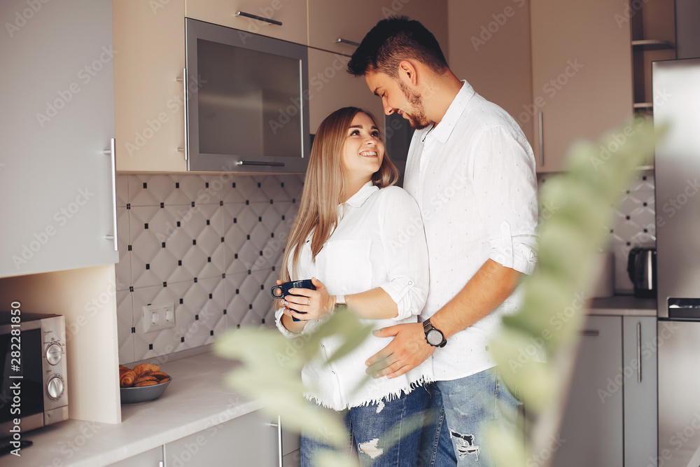 Loving couple have fun at home. Pretty blonde in a white blouse. Loving couple have fun at home. Pretty blonde in a white blouse.