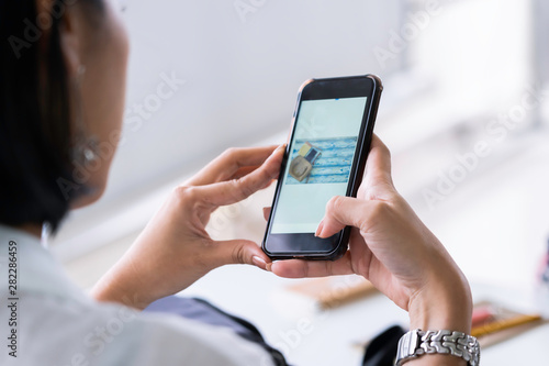 Woman hand using smart phone for shooting picture