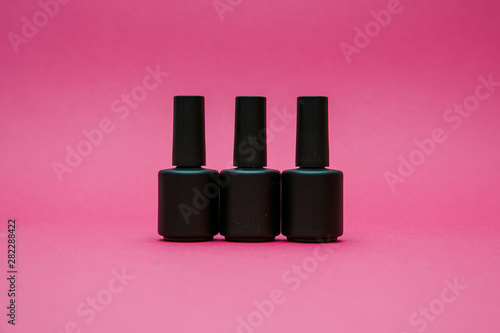 varnishes for nails on a red background in different compositions photo