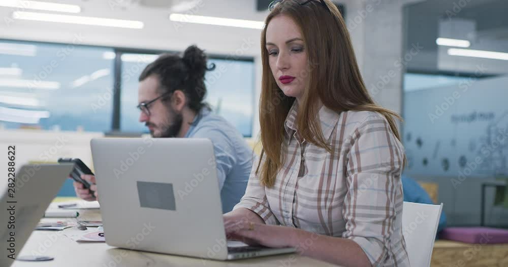 Young multiethnic business team of software developers working together using Young multiethnic business team of software developers working together using